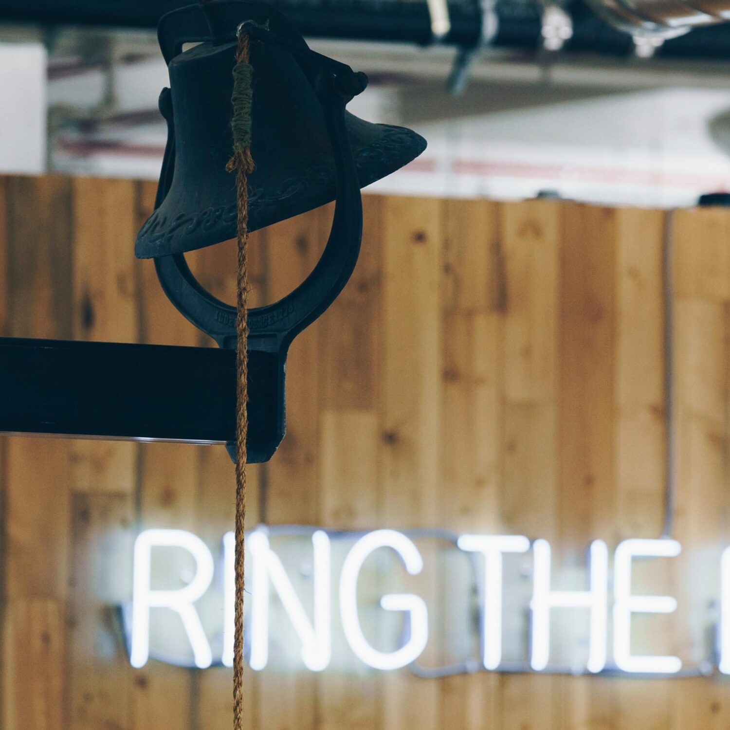 A neon sign that says 'Ring the Bell'